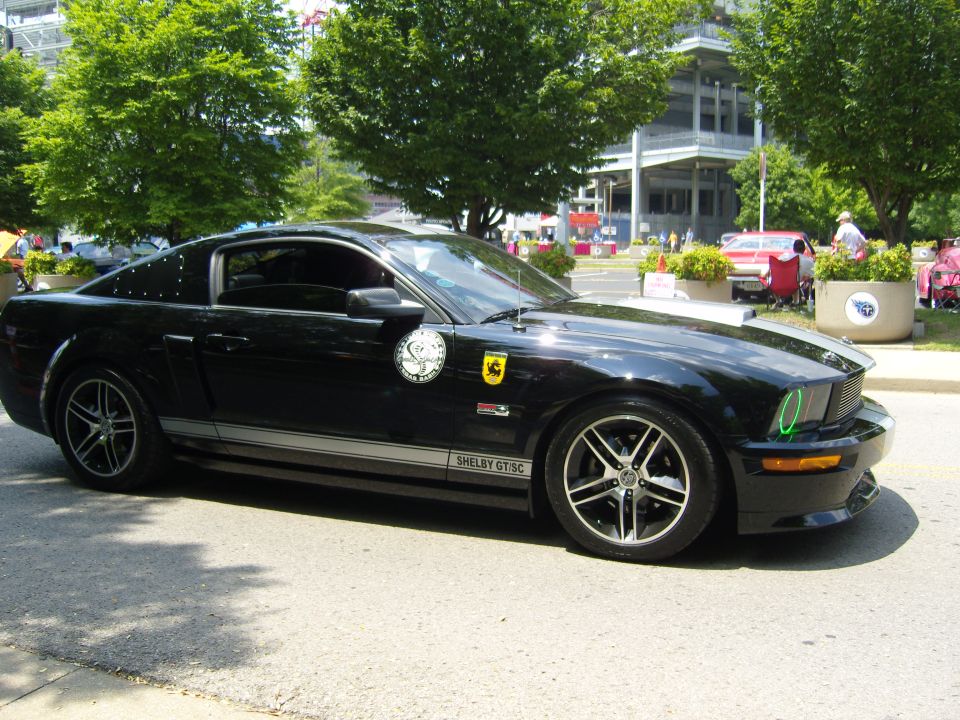 Black 2007 Ford Mustang Shelby GT500 side view with racing stripes