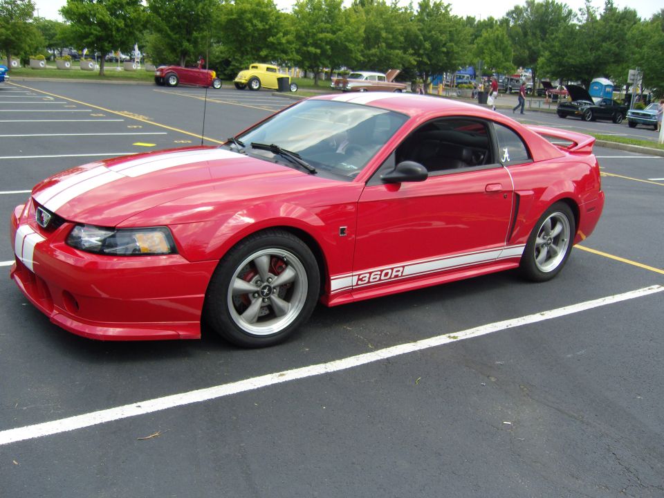 Red 2007 Ford Mustang coupe with white racing stripes and "1360R" side decal