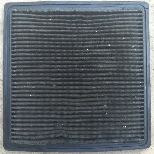 Dirty air filter with black pleats and a black frame. Supermotors.net logo in the corner
