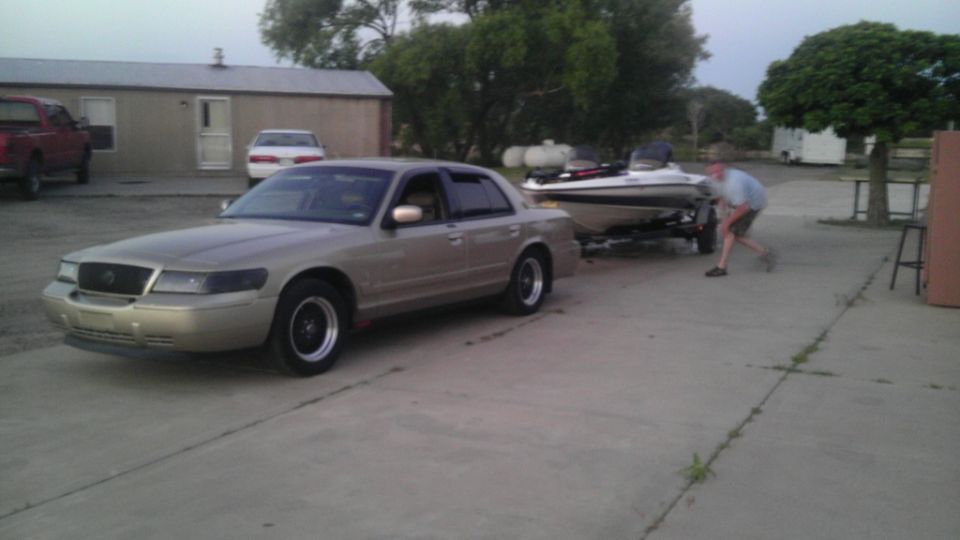 Tan 2000 Mercury Grand Marquis towing a boat