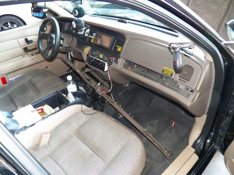2003 Ford Crown Victoria - Driver area of a Crown Victoria with the lower dash panel detached and wiring loose