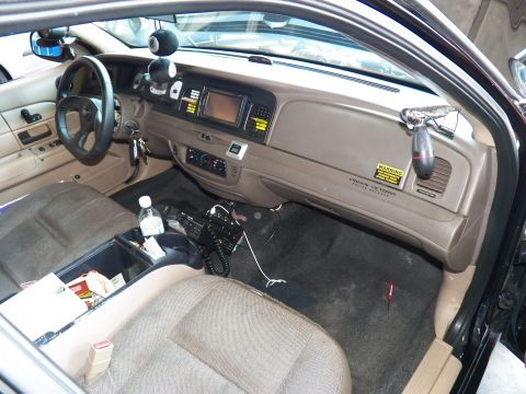 2003 Ford Crown Victoria - Crown Victoria dash labeled on glovebox, center screen and console wiring exposed during install.