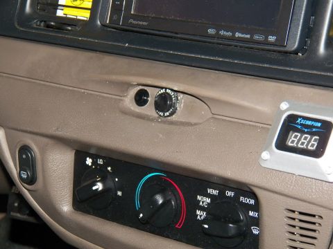 2003 Ford Crown Victoria - Detail of Pioneer DVD receiver and digital voltmeter set into a tan dashboard panel.