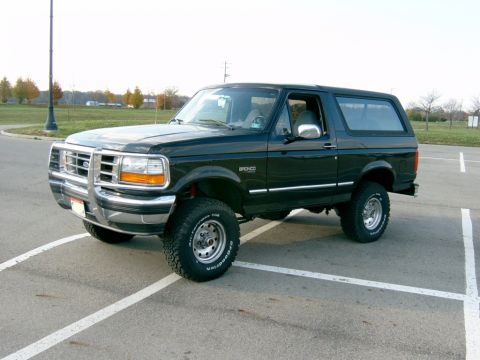 1995 Ford Bronco - This black 1995 Ford Bronco is shown in a 3/4 front view, parked in an outdoor lot.