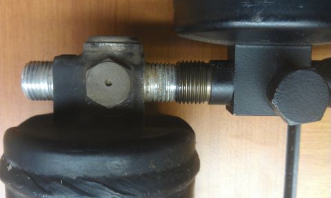 1991 Ford Festiva - This image shows a close-up of an automotive part with threaded connections, not a 1991 Ford Festiva.