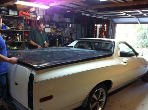 1976 Ford Ranchero - A 1976 Ford Ranchero is being worked on in a garage, a black bed cover.