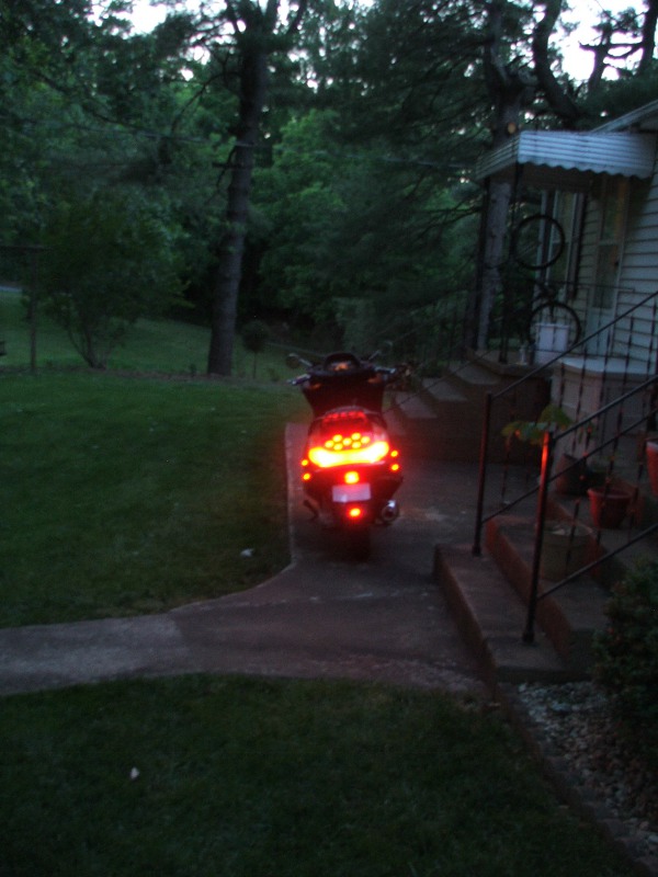 Scooter rear view with illuminated taillights