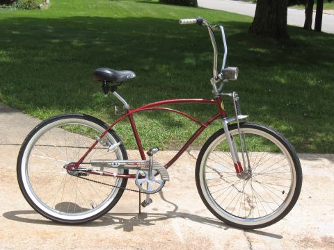 1994 Ford Bronco - Cruiser bicycle with whitewall tires and chrome handlebars parked on a concrete path.