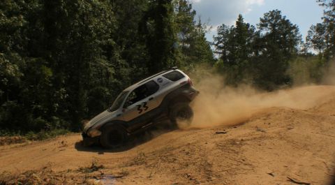 1999 Isuzu Vehicross - A silver 1999 Isuzu Vehicross navigates a dusty off-road course.