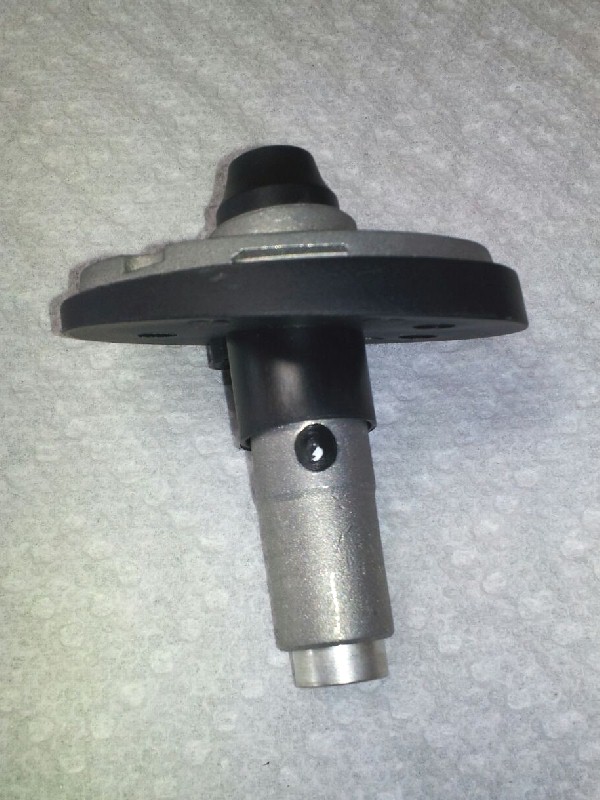 Metal automotive part with black rubber seal on a textured surface