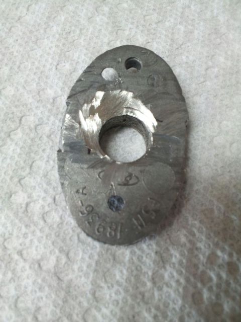 2011 Ford Ranger - A close-up view of a metal component with visible machining and stamped identification numbers.