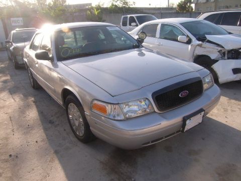 2005 Ford Crown Victoria - Front view of a silver 2005 Ford Crown Victoria parked outdoors.