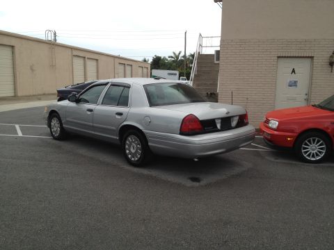 2005 Ford Crown Victoria - Silver 2005 Ford Crown Victoria parked in a lot next to a red vehicle.