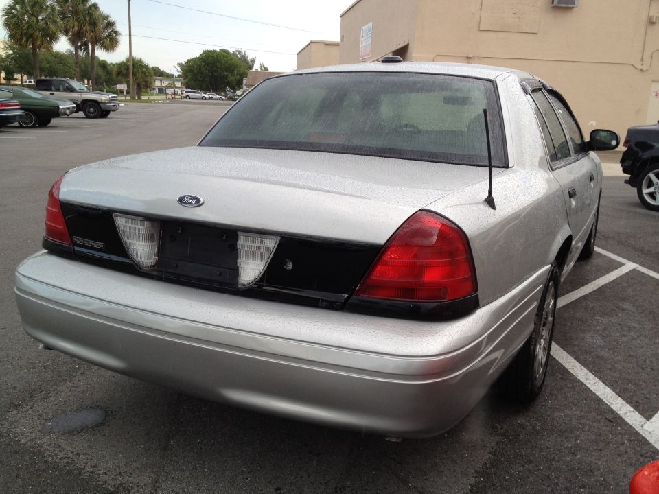 Silver Ford Crown Victoria, rear 3/4 view, showing taillights and trunk lid