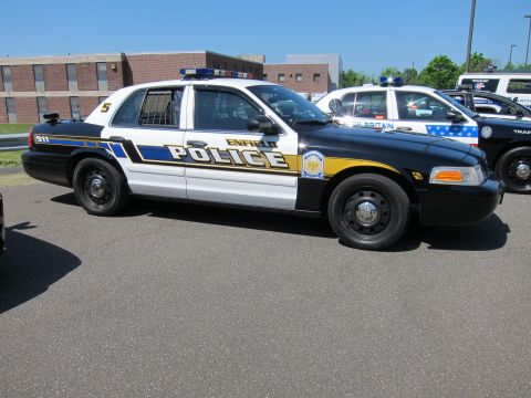 1991 Ford LTD Crown Victoria - Enfield Police Ford Crown Victoria cruiser in blue, white and yellow livery parked beside another police car.