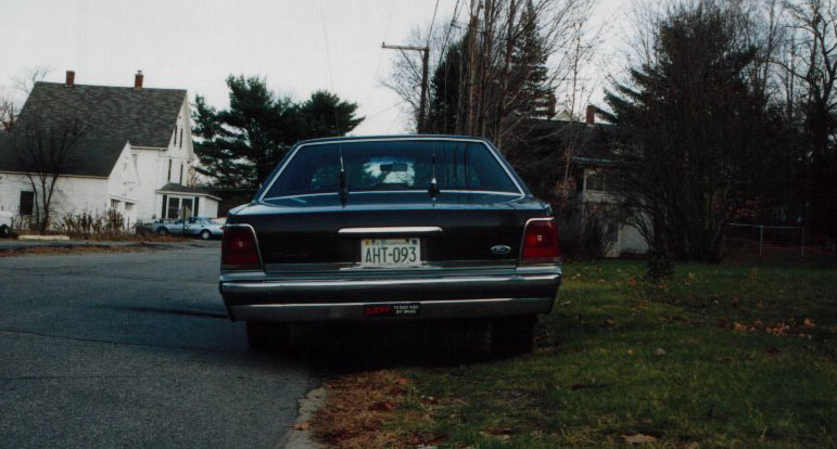 Dark green Ford LTD Crown Victoria sedan photographed from the rear on a residential street