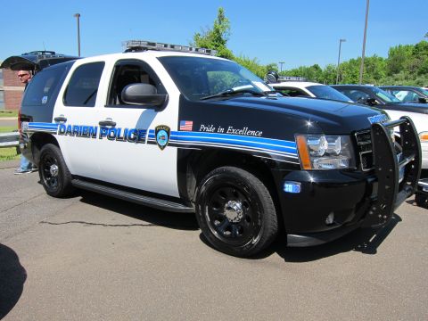 1991 Ford LTD Crown Victoria - black-and-white Darien Police Chevrolet Tahoe SUV with brush guard and roof light bar, Pride in Excellence.