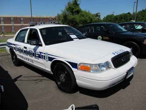 1991 Ford LTD Crown Victoria - white East Hartford Police Traffic Ford Crown Victoria cruiser viewed from the front quarter among other cars.