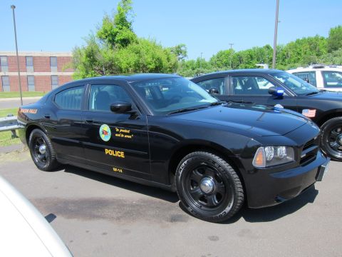 1991 Ford LTD Crown Victoria - Front-quarter view of a black Beacon Falls Police Dodge Charger with gold POLICE lettering in a parking lot.