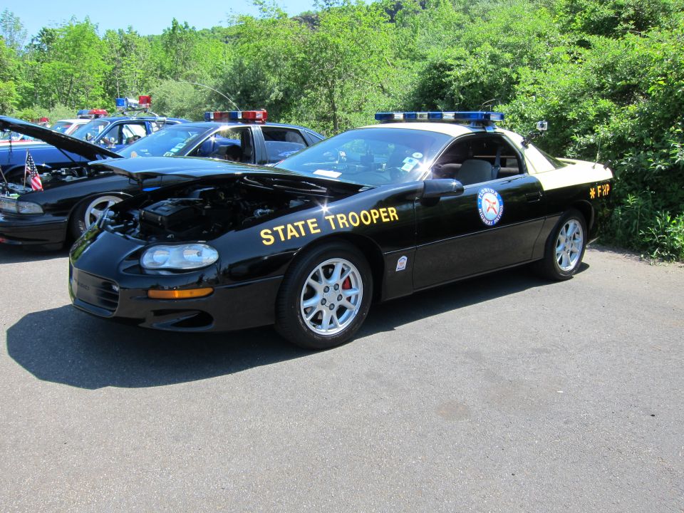 Black and tan Chevrolet Camaro STATE TROOPER police car with open hood