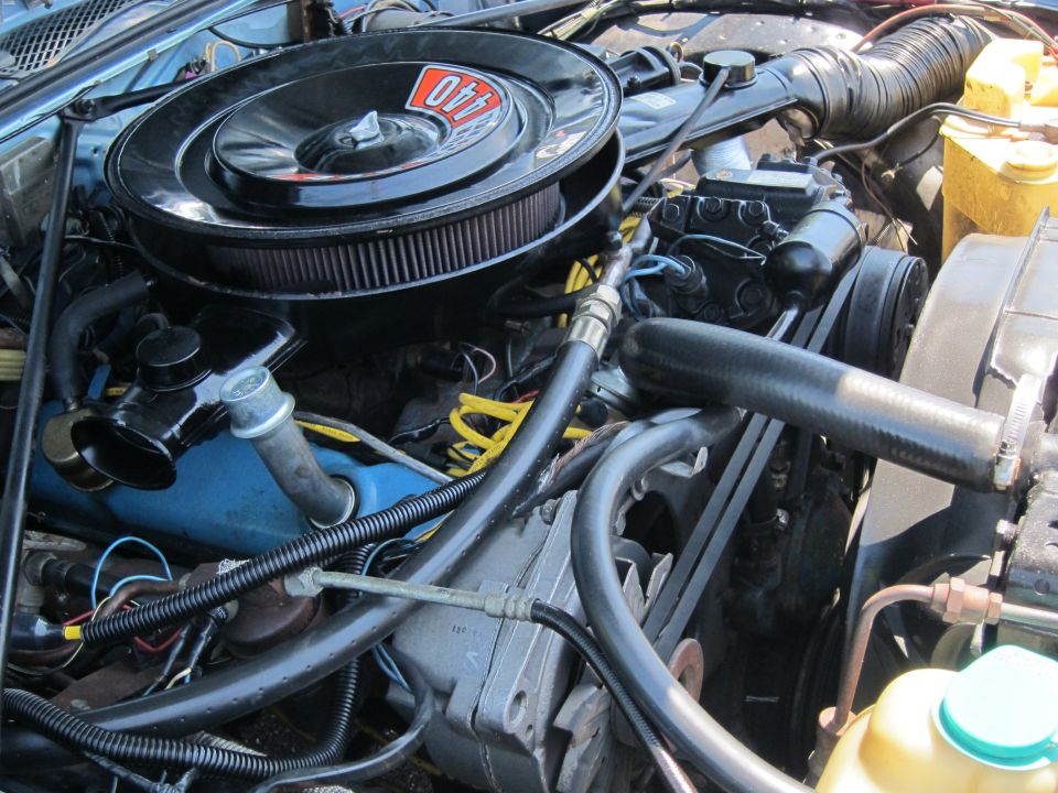 Engine bay close-up showing a black air cleaner and V8 engine