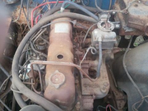 1978 Ford Bronco - Close-up of an engine bay, focusing on the carburetor and associated hoses.