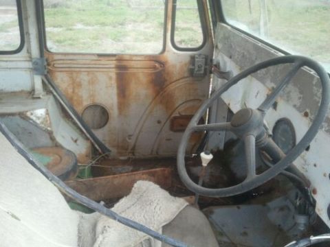 1978 Ford Bronco - The interior of a heavily rusted vehicle shows a large steering wheel and worn seats, with a SuperMotors watermark visible.