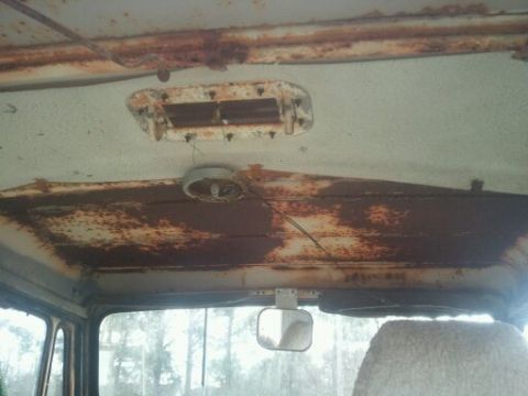 1978 Ford Bronco - The interior of this vehicle shows significant rust damage on the headliner and dashboard components.