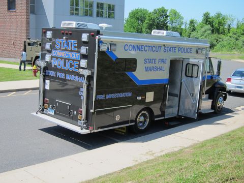 1991 Ford LTD Crown Victoria - Rear view of a black Connecticut State Police State Fire Marshal investigation box truck parked at a curb.