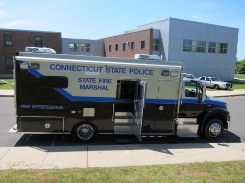 1991 Ford LTD Crown Victoria - Side profile of a black Connecticut State Police State Fire Marshal box truck with open side door at a curb.