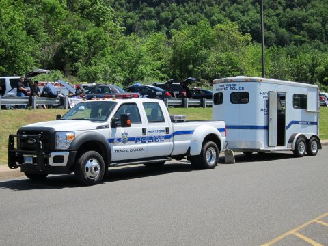 1991 Ford LTD Crown Victoria - white Hartford Police Traffic Division dually pickup hitched to a Hartford Mounted Police horse trailer in a lot.