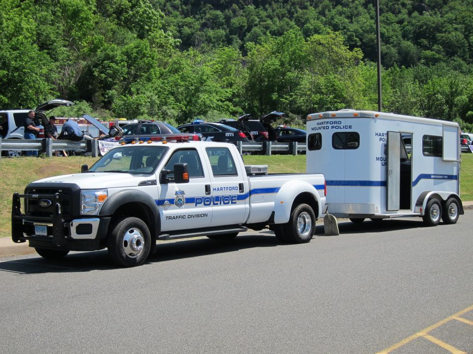 White Hartford Police Traffic Division crew-cab pickup towing a Hartford Mounted Police horse trailer