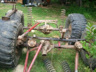 1978 Ford Bronco - The rear suspension and massive tires of a custom off-road vehicle are visible.