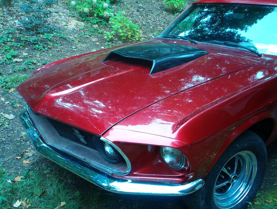 Red 1969 Ford Mustang Mach 1 hood and front fender with black scoop