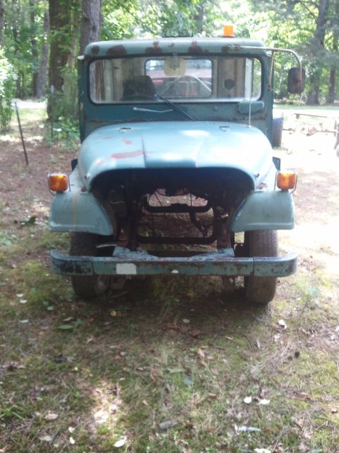 1978 Ford Bronco - This weathered truck sits in a grassy area, its front end exposed and showing signs of age.