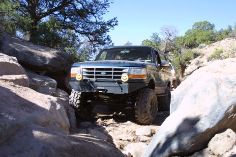 1994 Ford Bronco - This 1994 Ford Bronco navigates a challenging rocky trail with its front end prominently displayed.