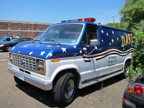 1991 Ford LTD Crown Victoria - blue and white Ford van with star graphics, wavy stripes and D.A.R.E. lettering, lettered To Resist Drugs And Violence.