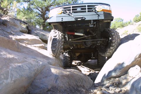 1994 Ford Bronco - This modified Ford Bronco is shown off-road, tackling a challenging rocky terrain.