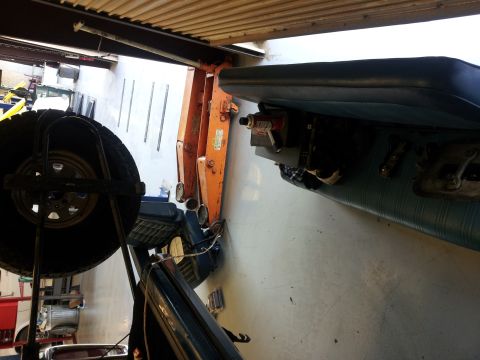 1979 Ford Bronco - A spare tire is mounted inside a vehicle, obscuring much of the interior and a piece of orange equipment.