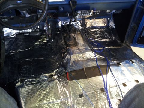 1979 Ford Bronco - Soundproofing material and wiring are visible on the floor of this vehicle's interior.