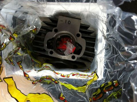 1981 Garelli Rally Sport - A motorcycle cylinder part, possibly a Garelli NOI Malossi Reed Kit 64cc, is shown in its packaging.