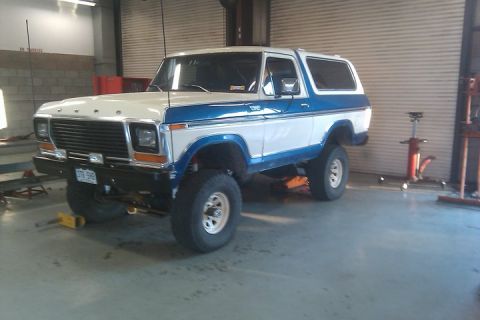 1979 Ford Bronco - This 1979 Ford Bronco is lifted and appears to be undergoing maintenance in a garage.