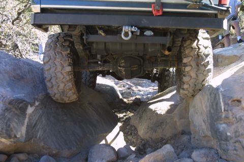 1994 Ford Bronco - The vehicle's undercarriage is visible as it maneuvers over a rocky trail.
