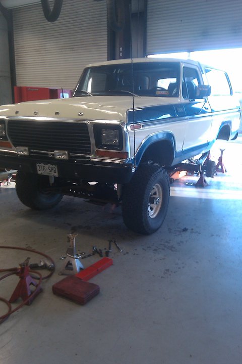1979 Ford Bronco - This 1979 Ford Bronco is being worked on in a garage, elevated on jack stands.