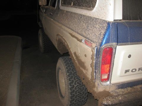 1979 Ford Bronco - Rear view of a mud-splattered 1978 Ford Bronco showing the tailgate and quarter panel.