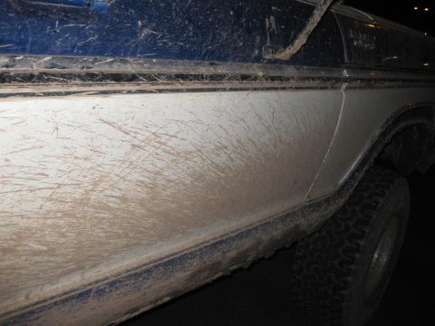 1979 Ford Bronco - This 1979 Ford Bronco shows off its off-road capabilities with extensive mud splatter on its side.