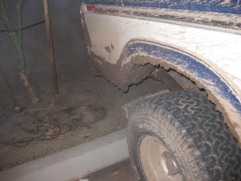 1979 Ford Bronco - This vehicle appears to be covered in mud, obscuring some of its details and making year identification difficult.