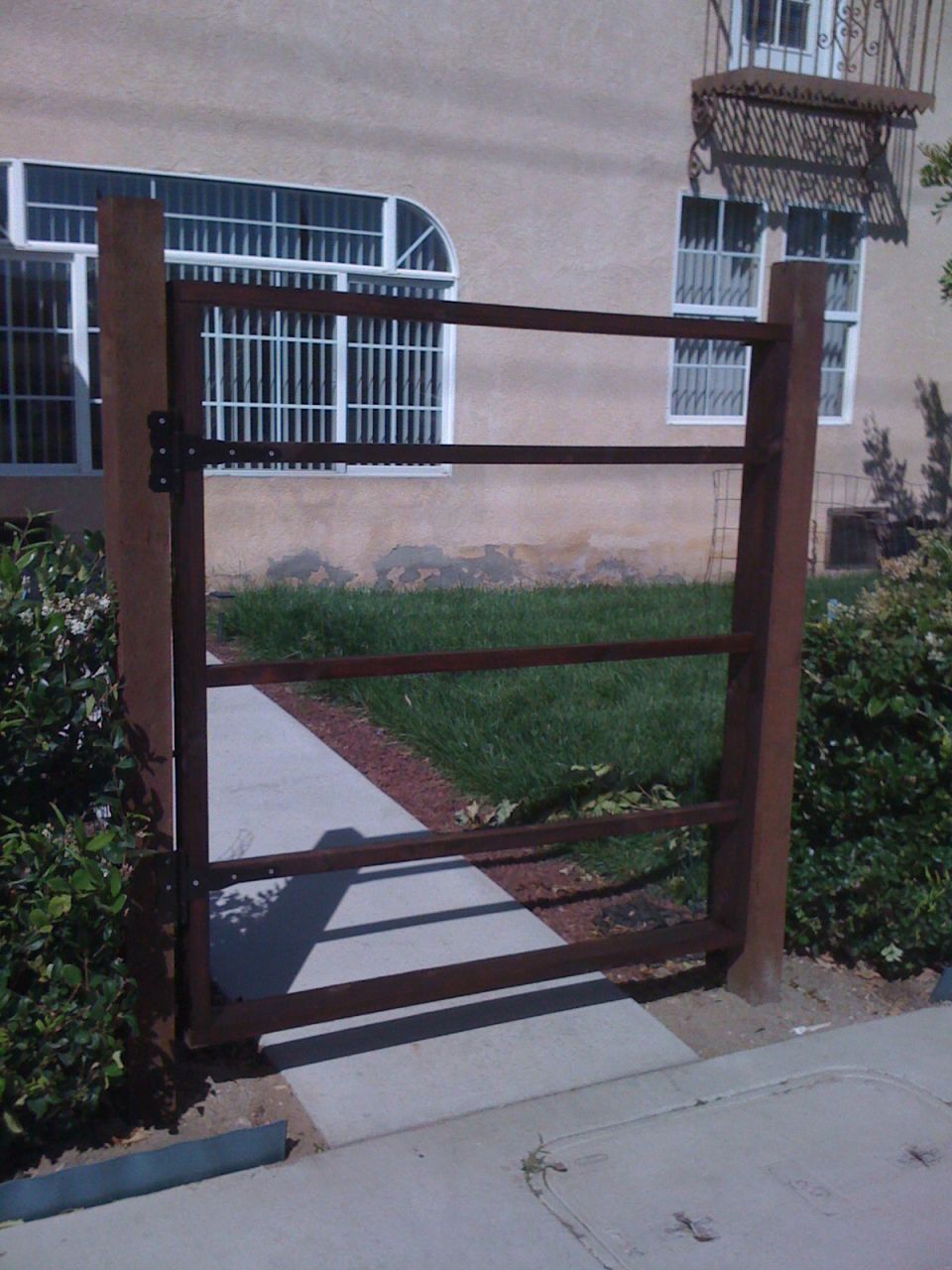Metal gate in front of building with barred windows