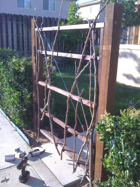 1968 Ford Mustang - A wooden gate is being constructed with branches as decoration, with a drill nearby.