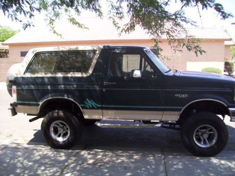 1993 Ford Bronco - This 1993 Ford Bronco is seen from the side, a two-tone paint scheme and a spare tire mounted on the rear.